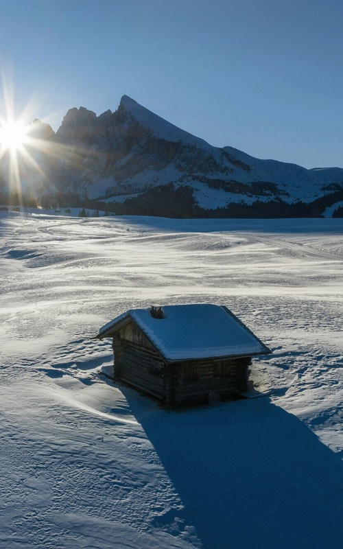 Farm stay on a snow-covered meadow in the Alps