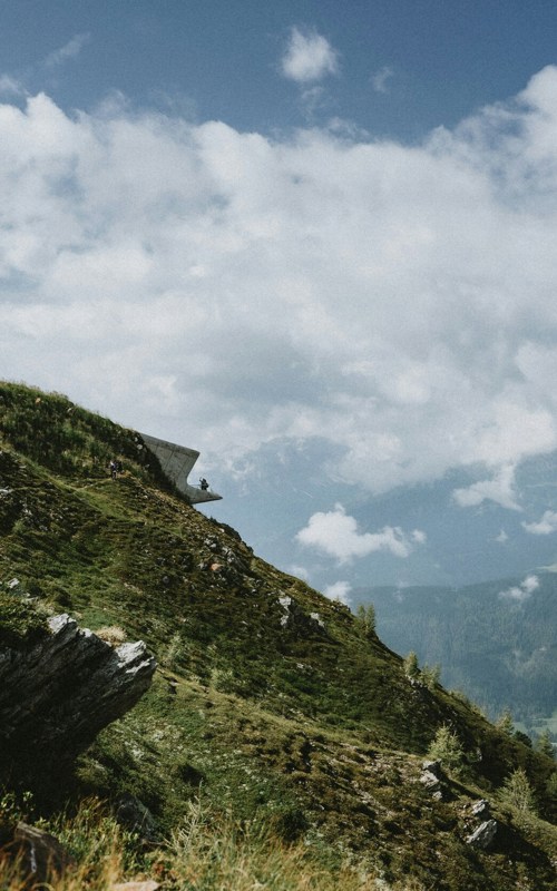 Futuristic concrete building on a mountainside