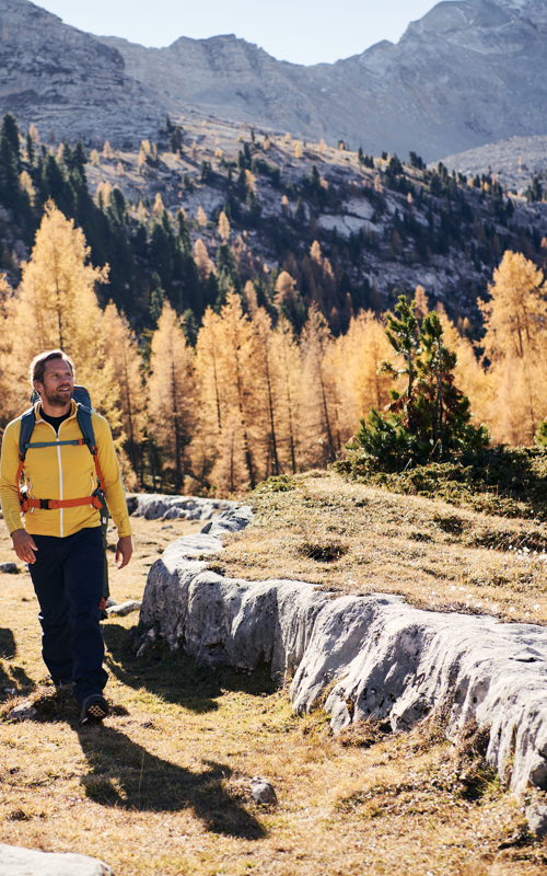 Two hikers in a autumn mountain landscape near S. Vigilio di Marebbe