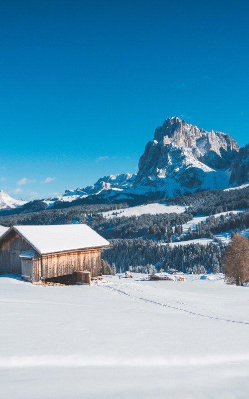 Winter landscape and dolomites against a blue sky
