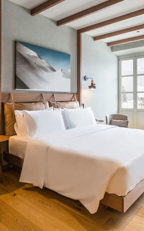 Hotel room with double bed and natural materials